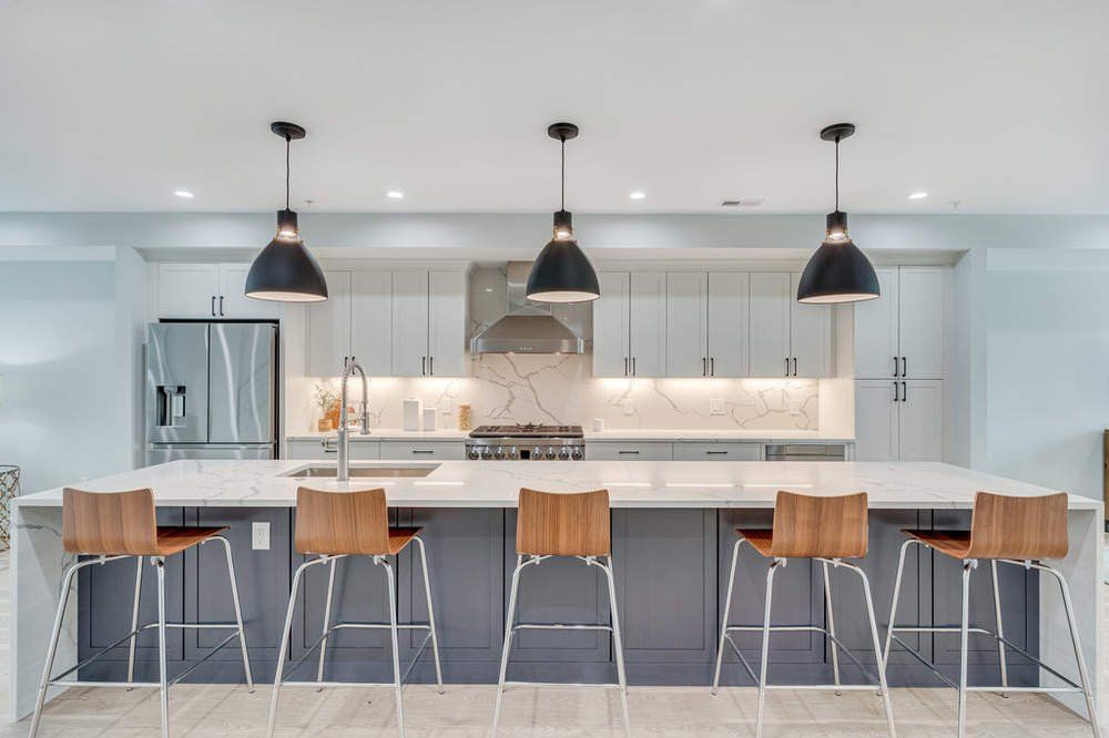 A kitchen with a large island and stools