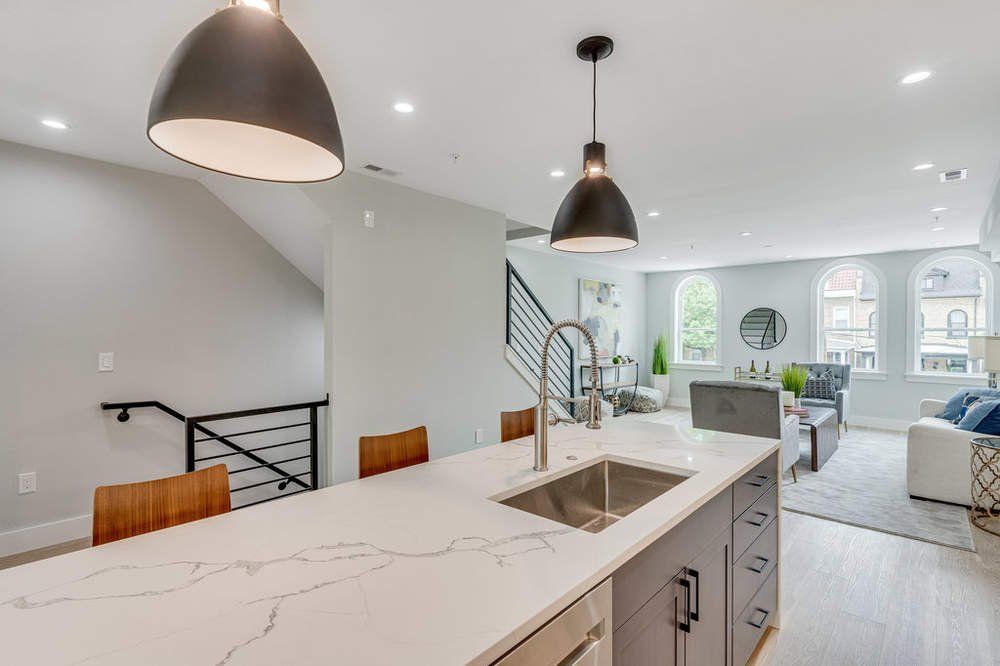 A kitchen with a large island and a sink.