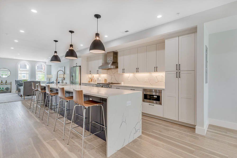 A large kitchen with a large island and stools.