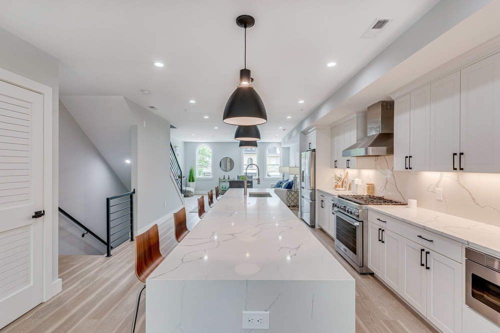 A kitchen with white cabinets and stainless steel appliances