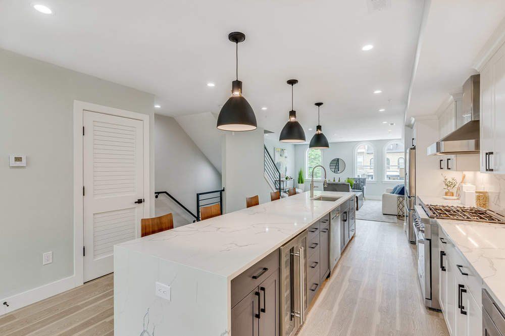 A kitchen with a large island in the middle of it.
