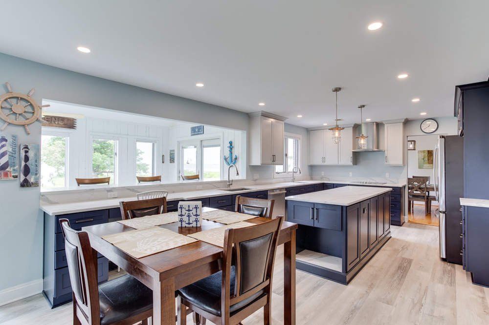 A kitchen with a table and chairs in it.