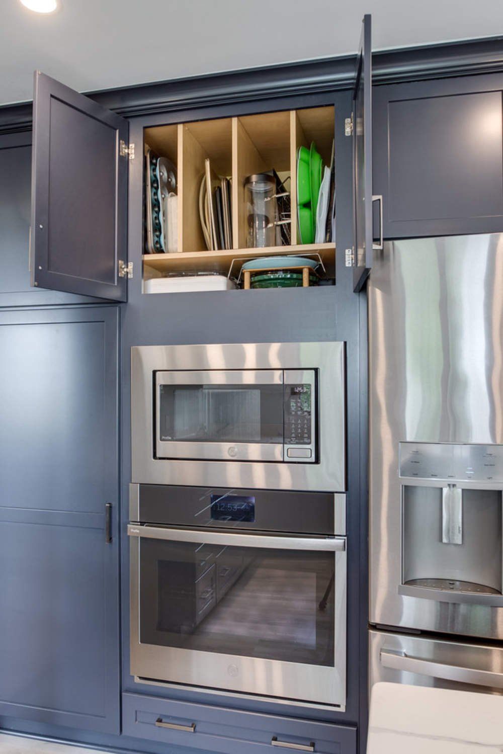 A kitchen with stainless steel appliances and a microwave oven.