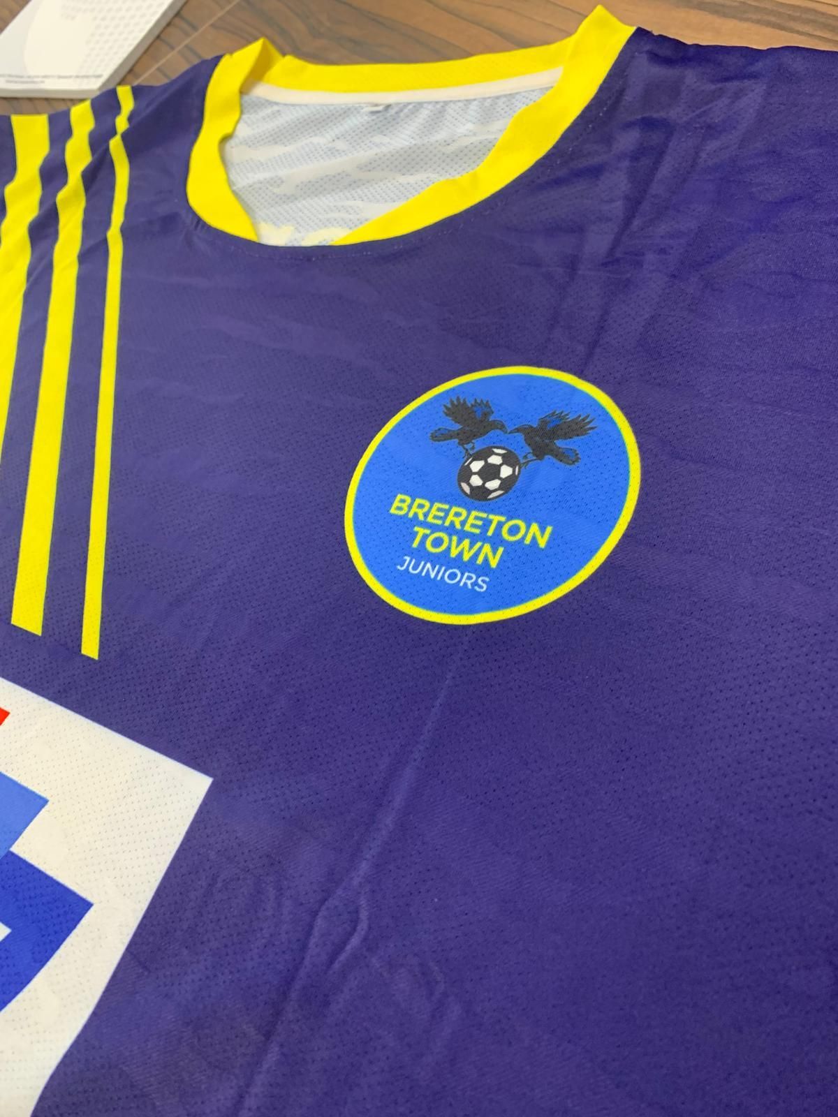 WhiteLodge Purple soccer jersey with yellow accents and a blue Brereton Town Juniors logo.
