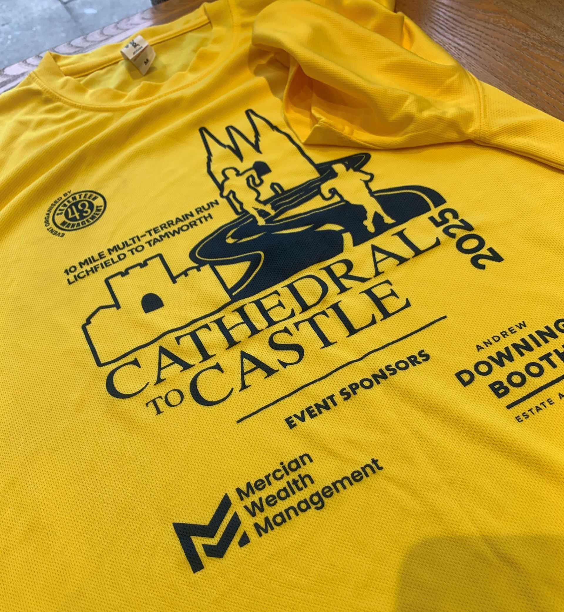 WhiteLodge Yellow Cathedral to Castle 2025 race shirt; logo with castle outline, sponsors.