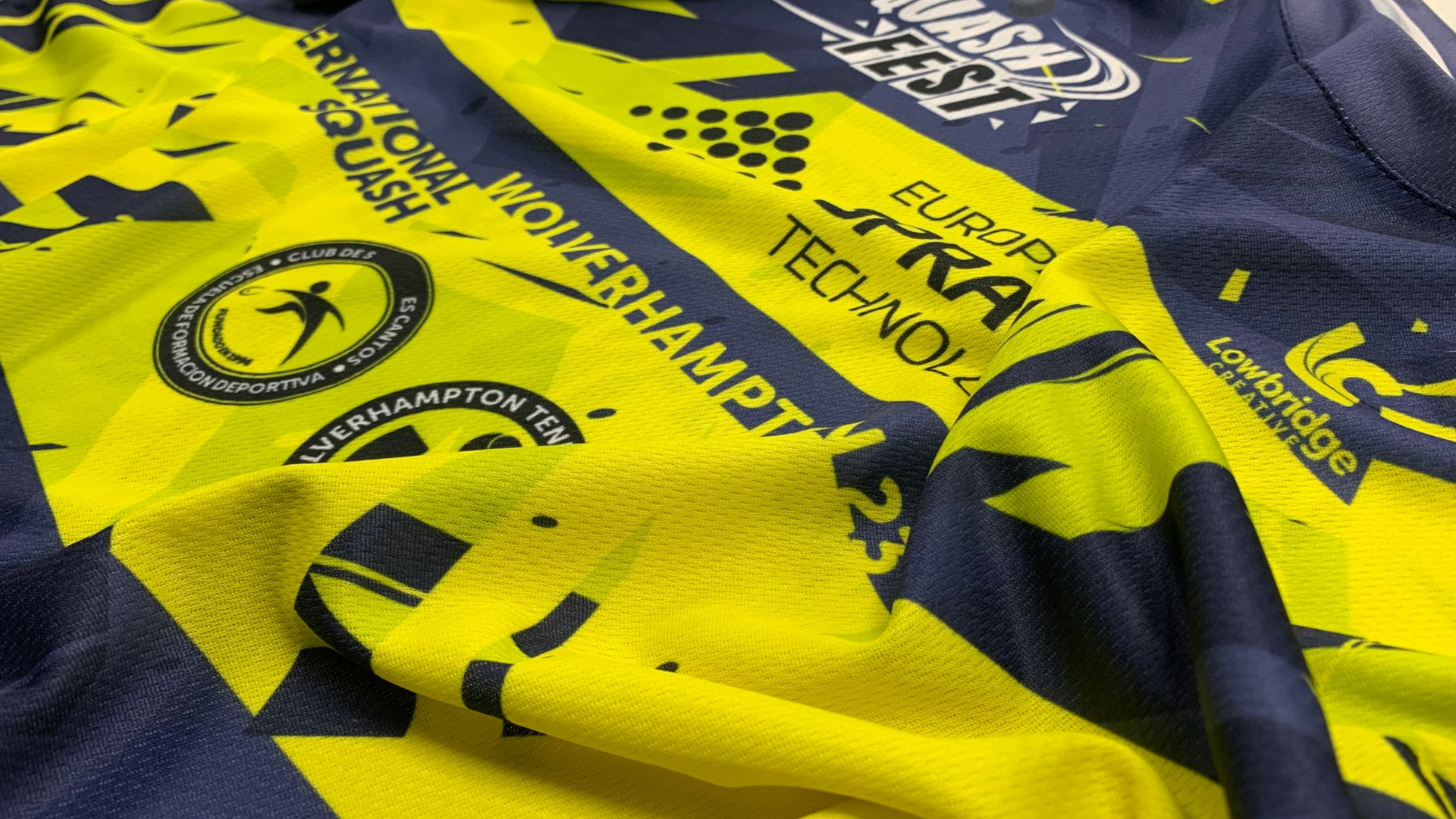 WhiteLodge Yellow and navy sports jersey with text and logos, including 