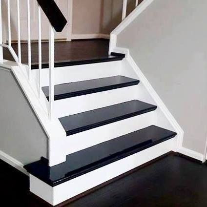 Person sanding wooden floor with power sander, wearing gloves.