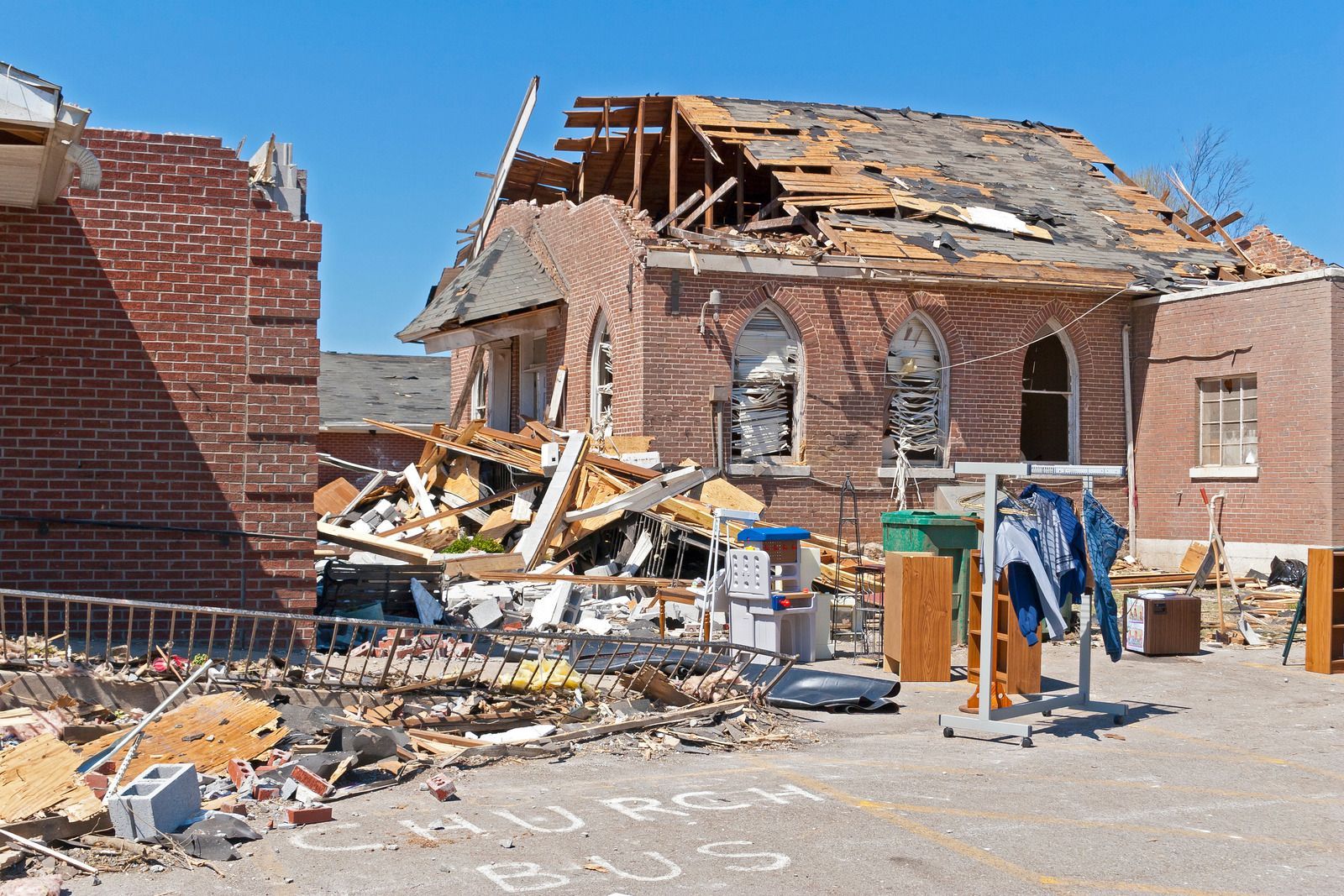 A brick building with a roof that has fallen down