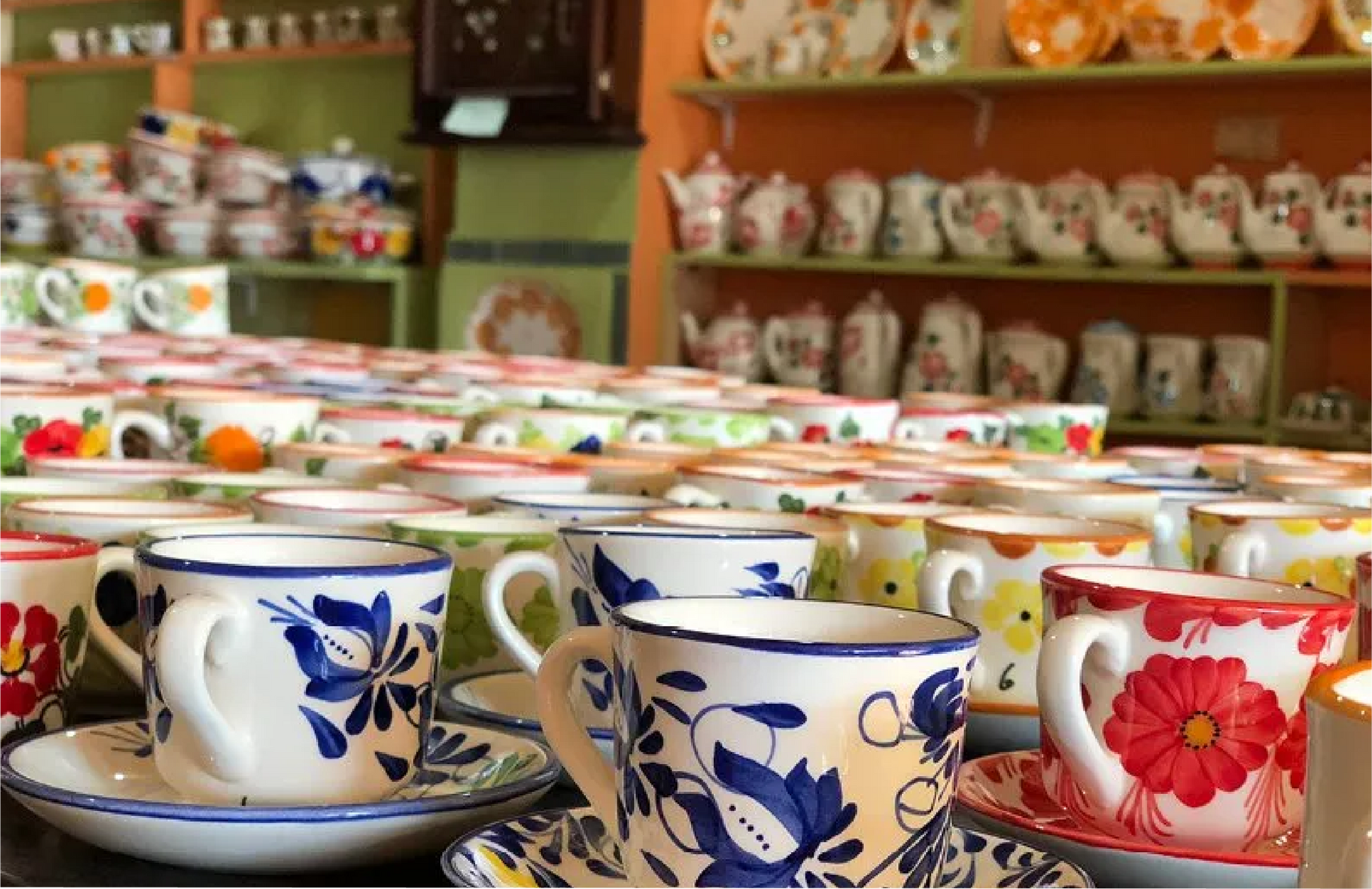 Un montón de tazas y platillos están sobre una mesa en una tienda.