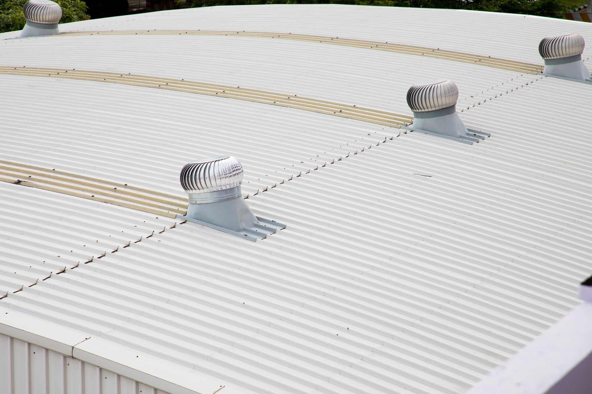 White metal roof with four spinning vents.