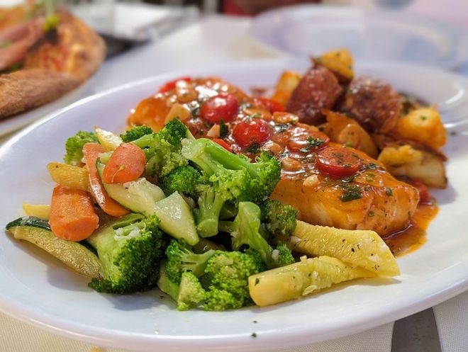 A white plate topped with broccoli , carrots and potatoes