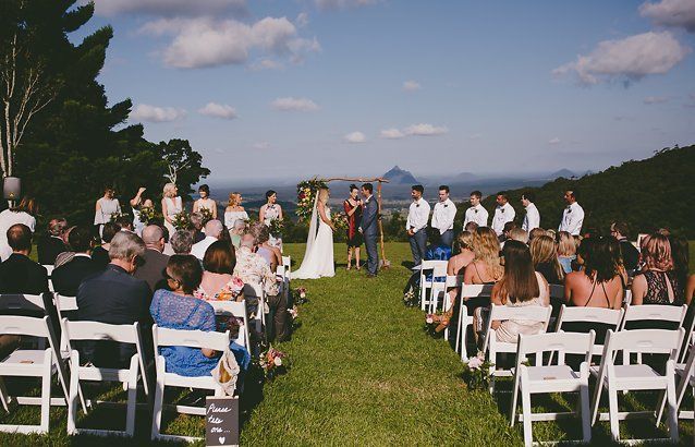celebrant with rted scarf marrying couple with bridal party of ten at Maleny Retreat in the hinterland