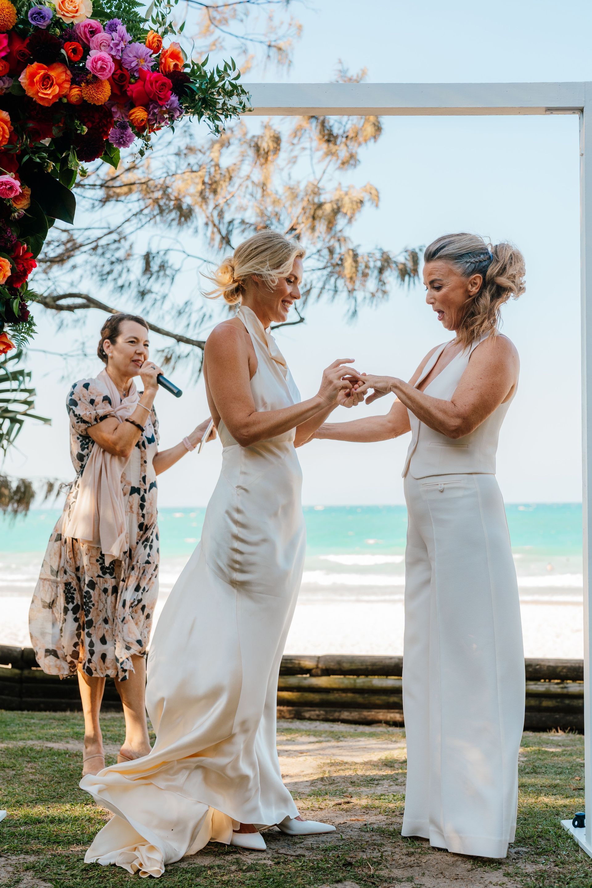 Noosa little cove platform, 2 women elope saying wedding vows