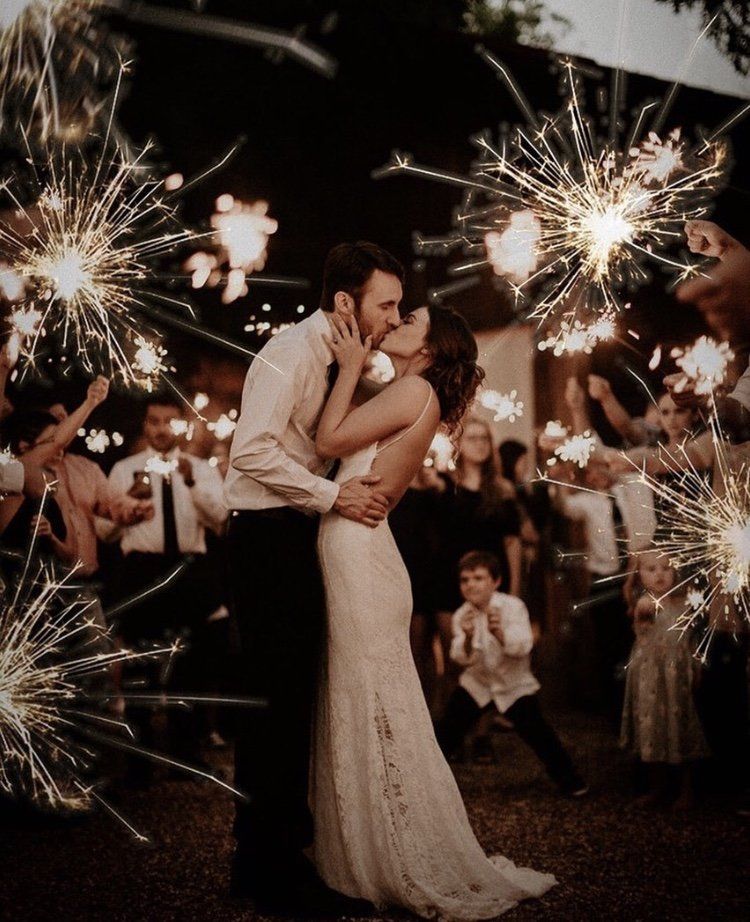 couple kissing after their Noosa wedidng sparkler exit a night with all guests holding sparklers and cheering