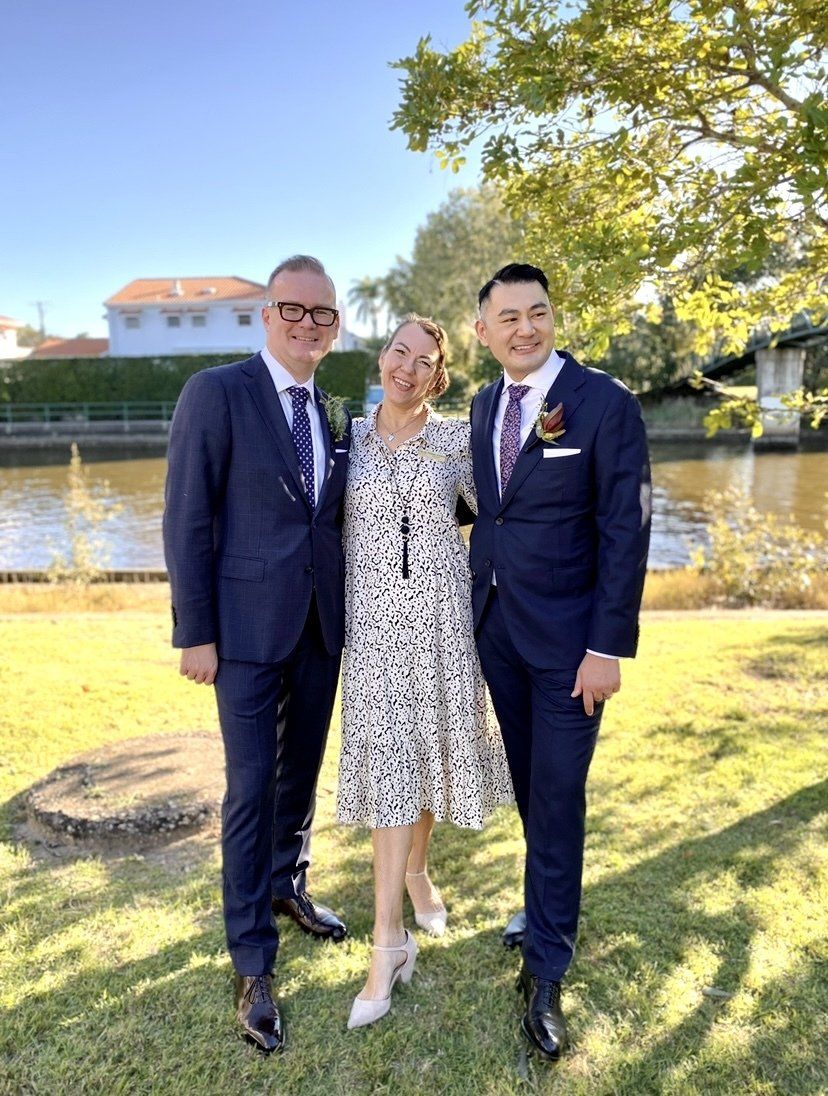 noosa wedding with 2 same sex men in dark suits at noosa waterfront restaurant