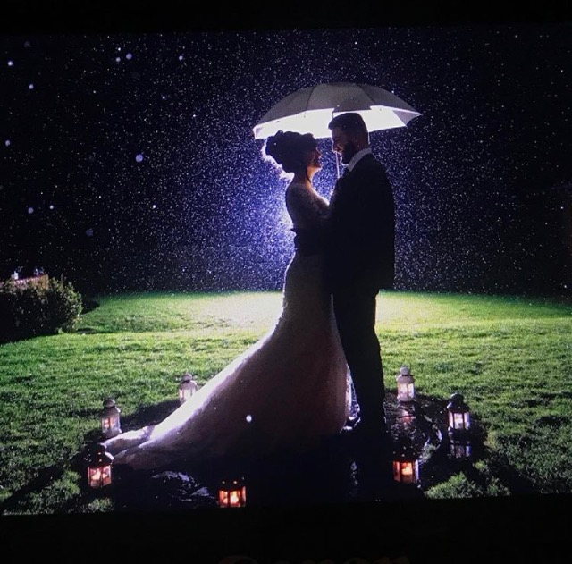 starry sky with rain drops and bridal couple dancing with umbrella