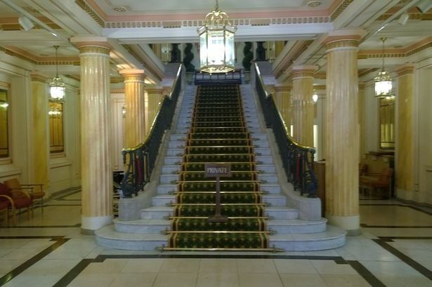 elegant steps inside a registry office, carpet down middle and marble pillars