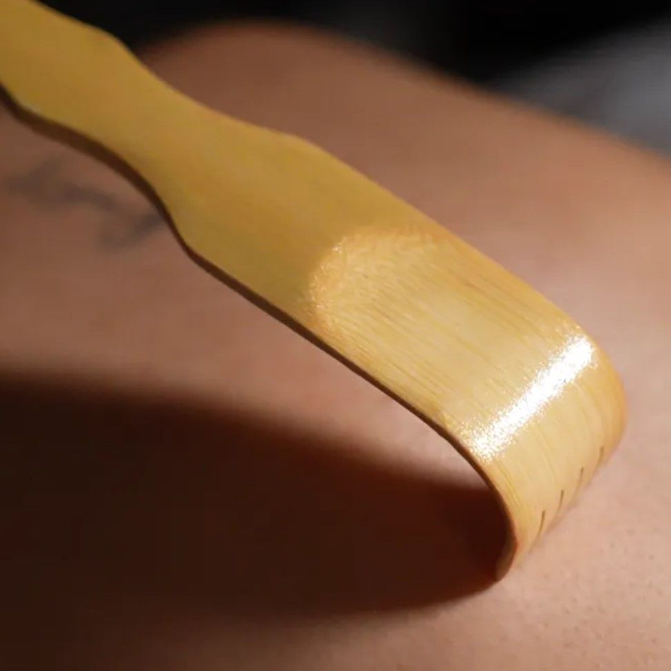 Bamboo back scratcher scratching skin.