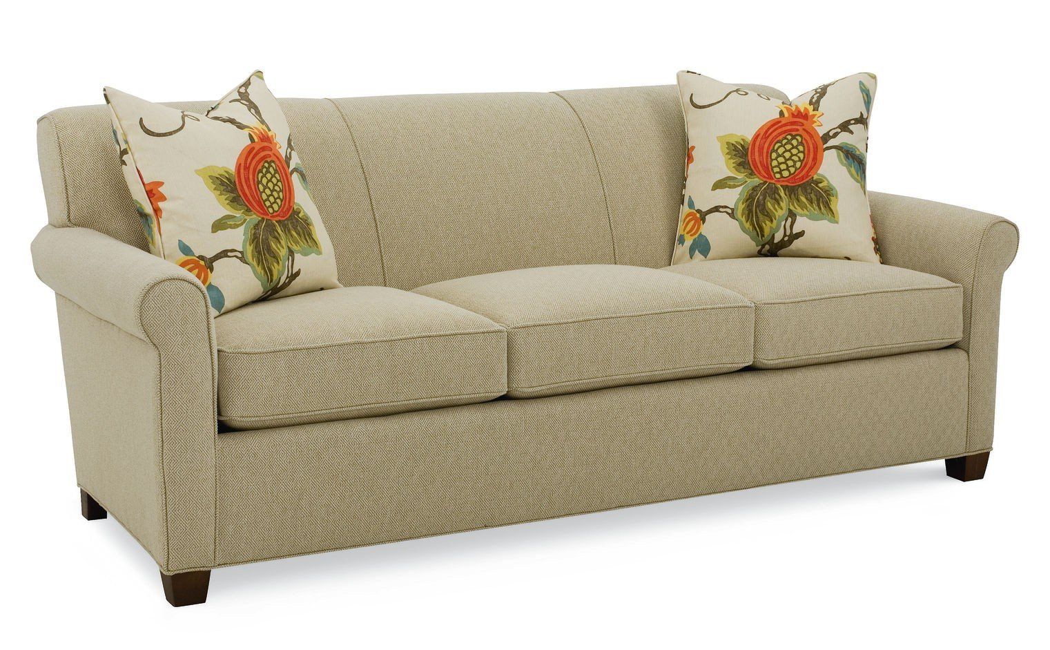 a beige couch with floral pillows on it