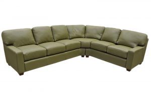 a green leather sectional couch on a white background