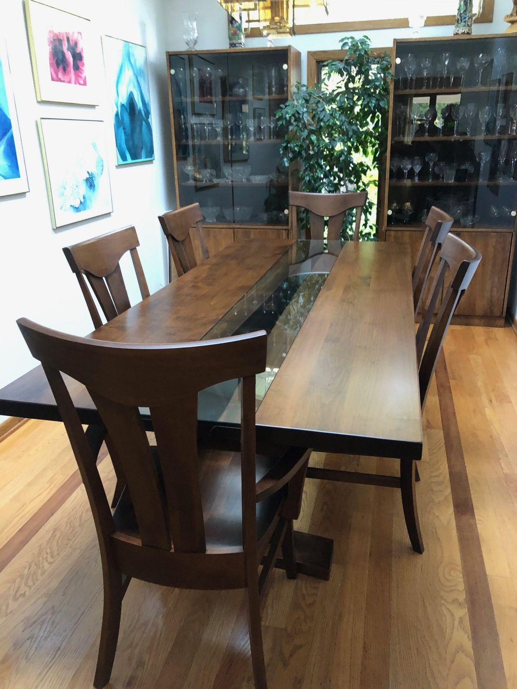 a wooden table and chairs in a dining room