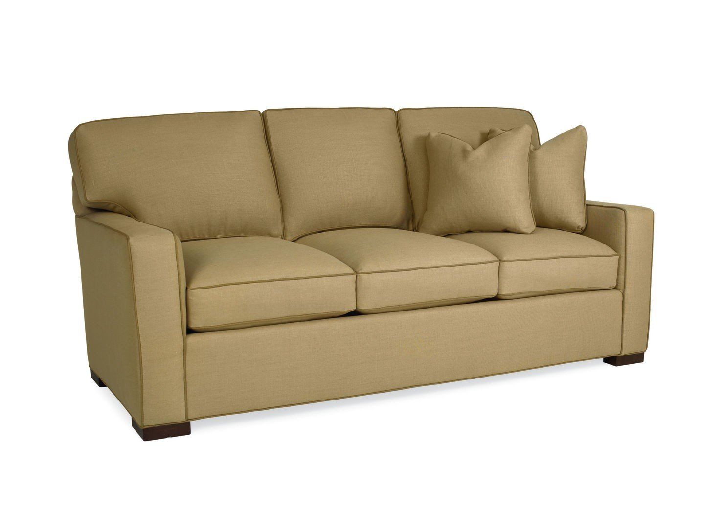a tan couch with two pillows on it on a white background