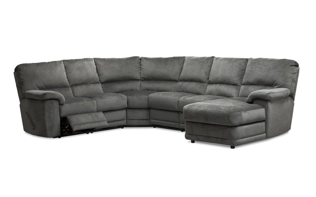 a gray sectional couch with a chaise lounge on a white background .