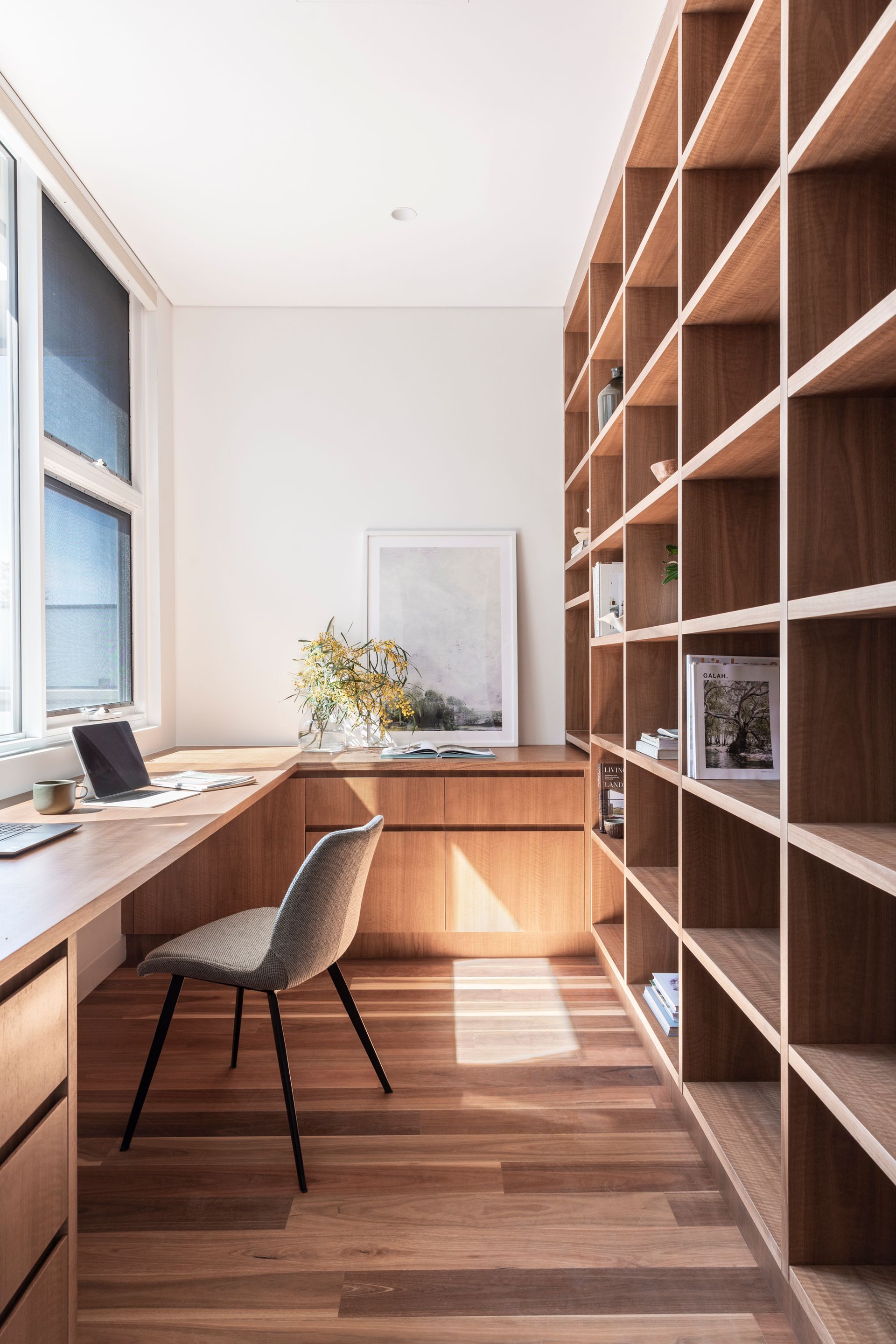 A study with wooden shelving and chair — Paiano Custom Kitchens In Corrimal, NSW