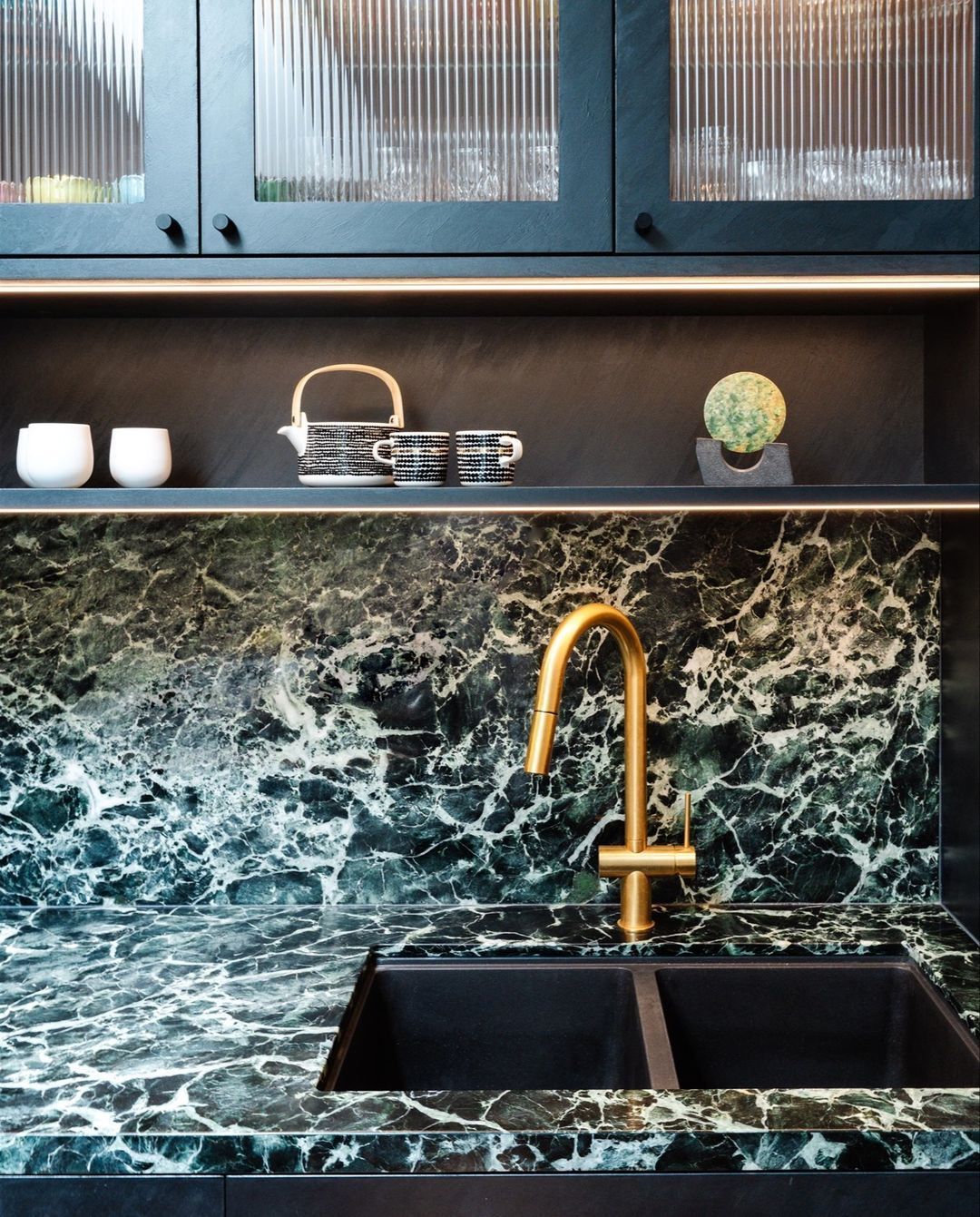 A Kitchen With a Bottle of Wine and Two Glasses of Wine on the Counter — Paiano Custom Kitchens In Corrimal, NSW