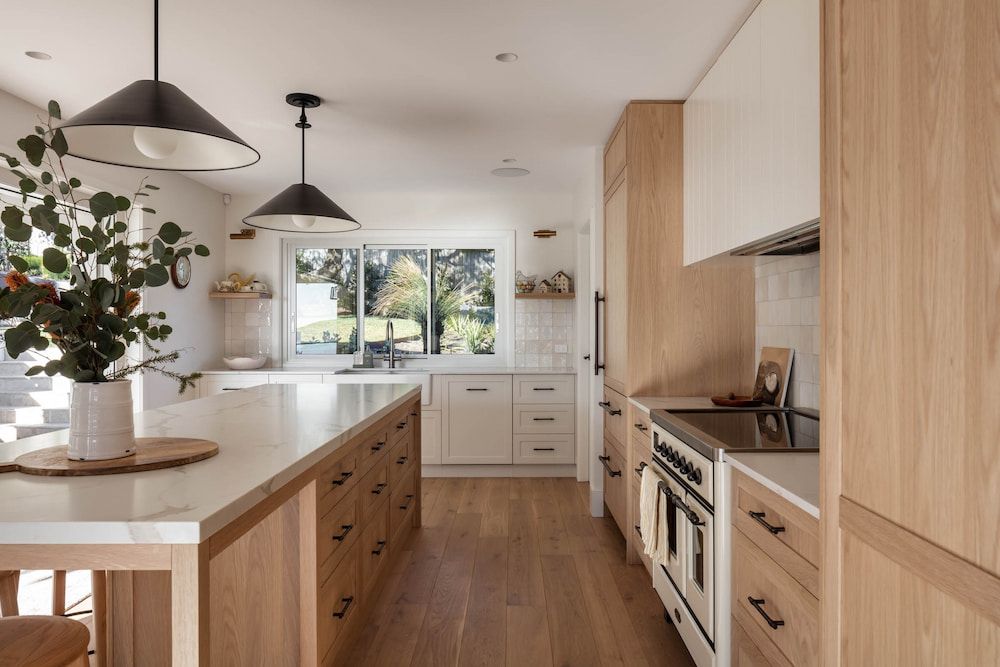 A Kitchen With Wooden Cabinets and White Counter Tops — Paiano Custom Kitchens In Corrimal, NSW