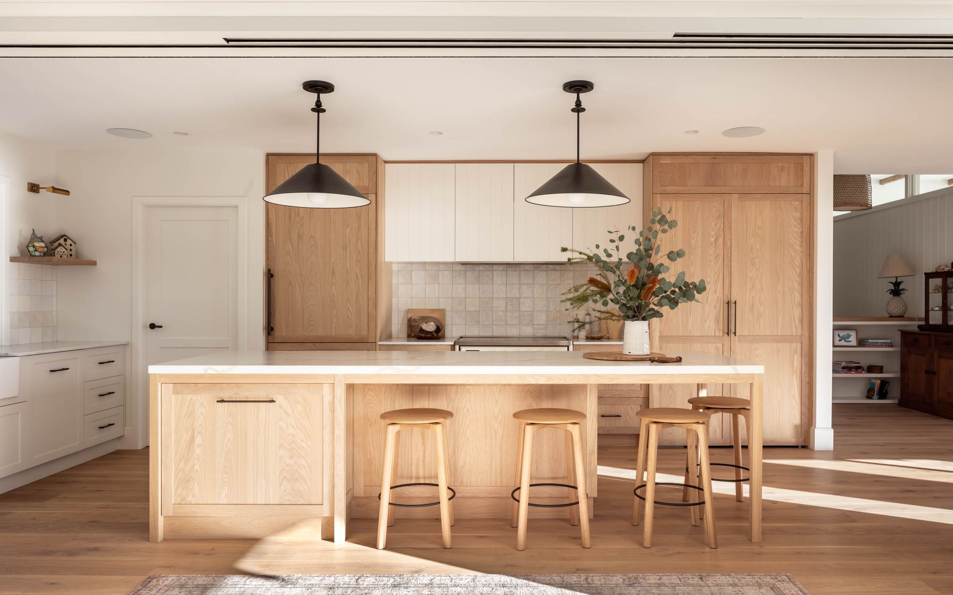 A Kitchen With Wooden Cabinets, Stainless Steel Appliances, and a Large Island — Paiano Custom Kitchens In Corrimal, NSW