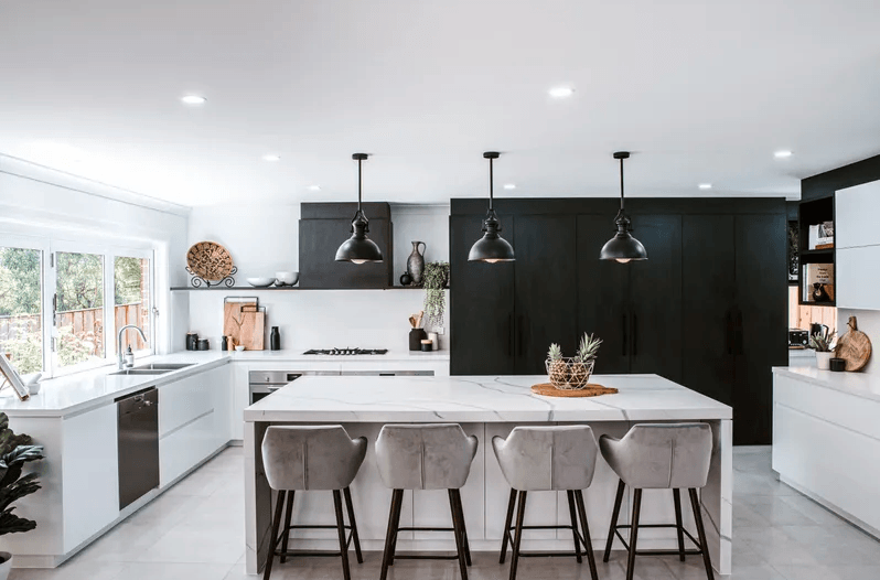 A Kitchen With a Large Island and Stools in It — Paiano Custom Kitchens In Corrimal, NSW