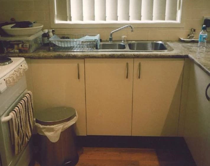 A Kitchen With Two Sinks and a Trash Can — Paiano Custom Kitchens In Corrimal, NSW