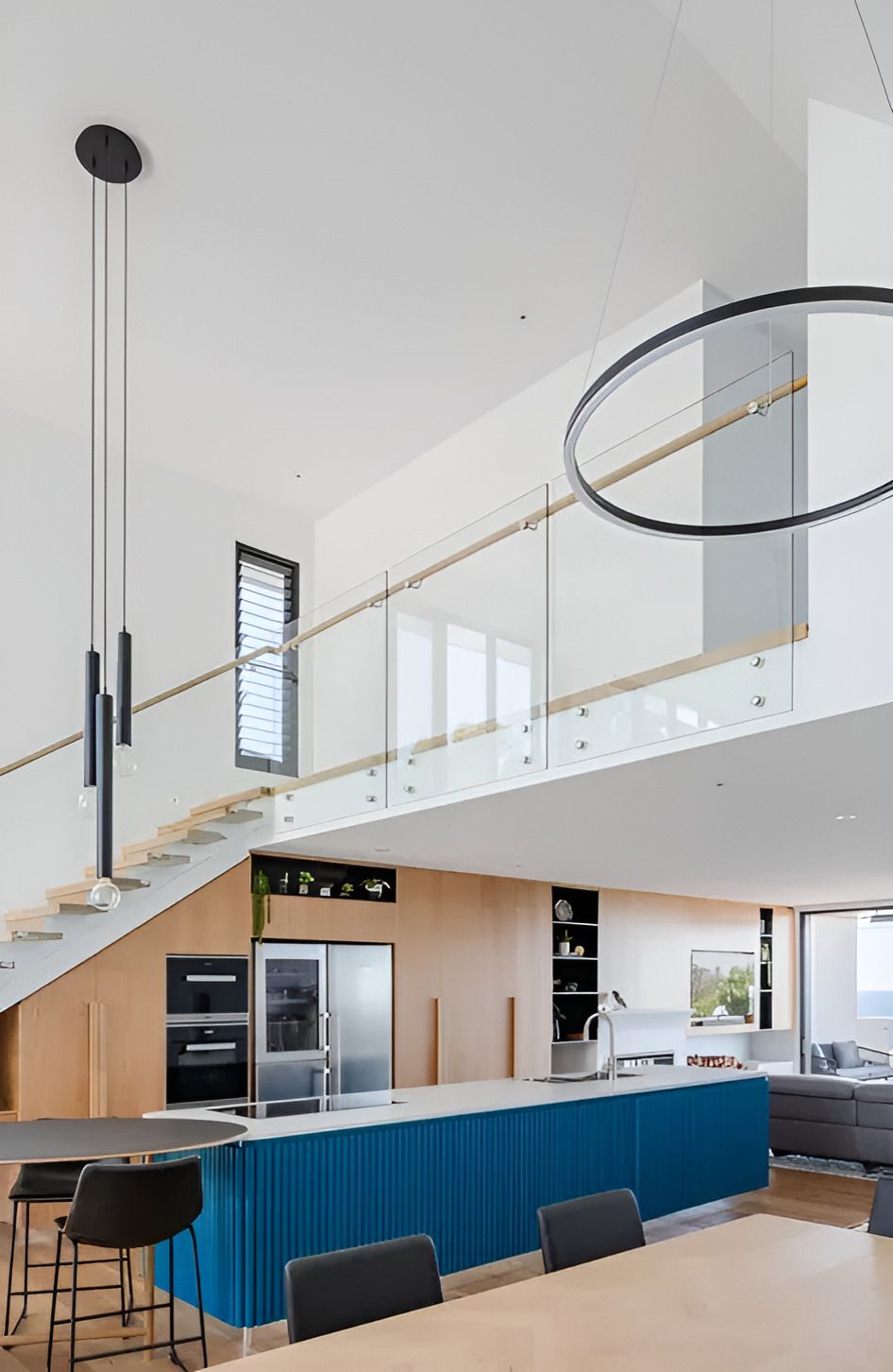 A Kitchen With a Blue Island and a Staircase — Paiano Custom Kitchens In Corrimal, NSW