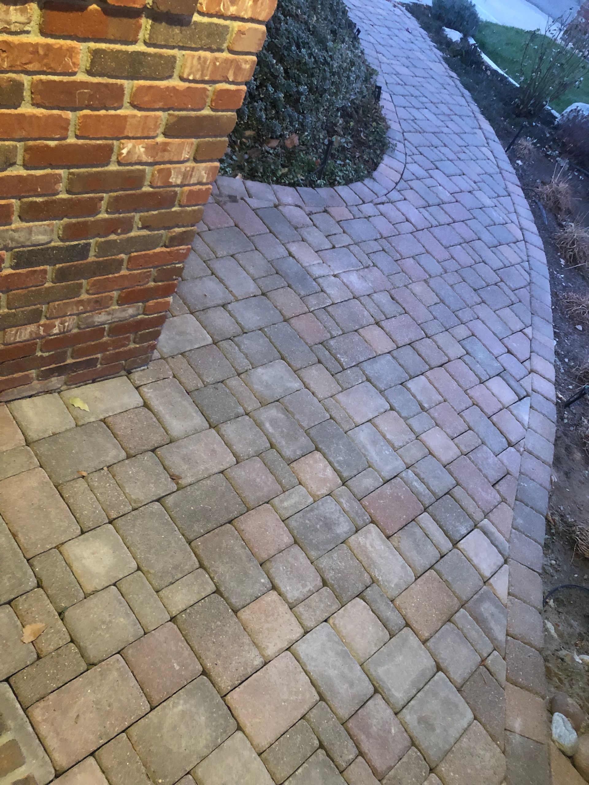 A brick walkway with a brick wall in the background.
