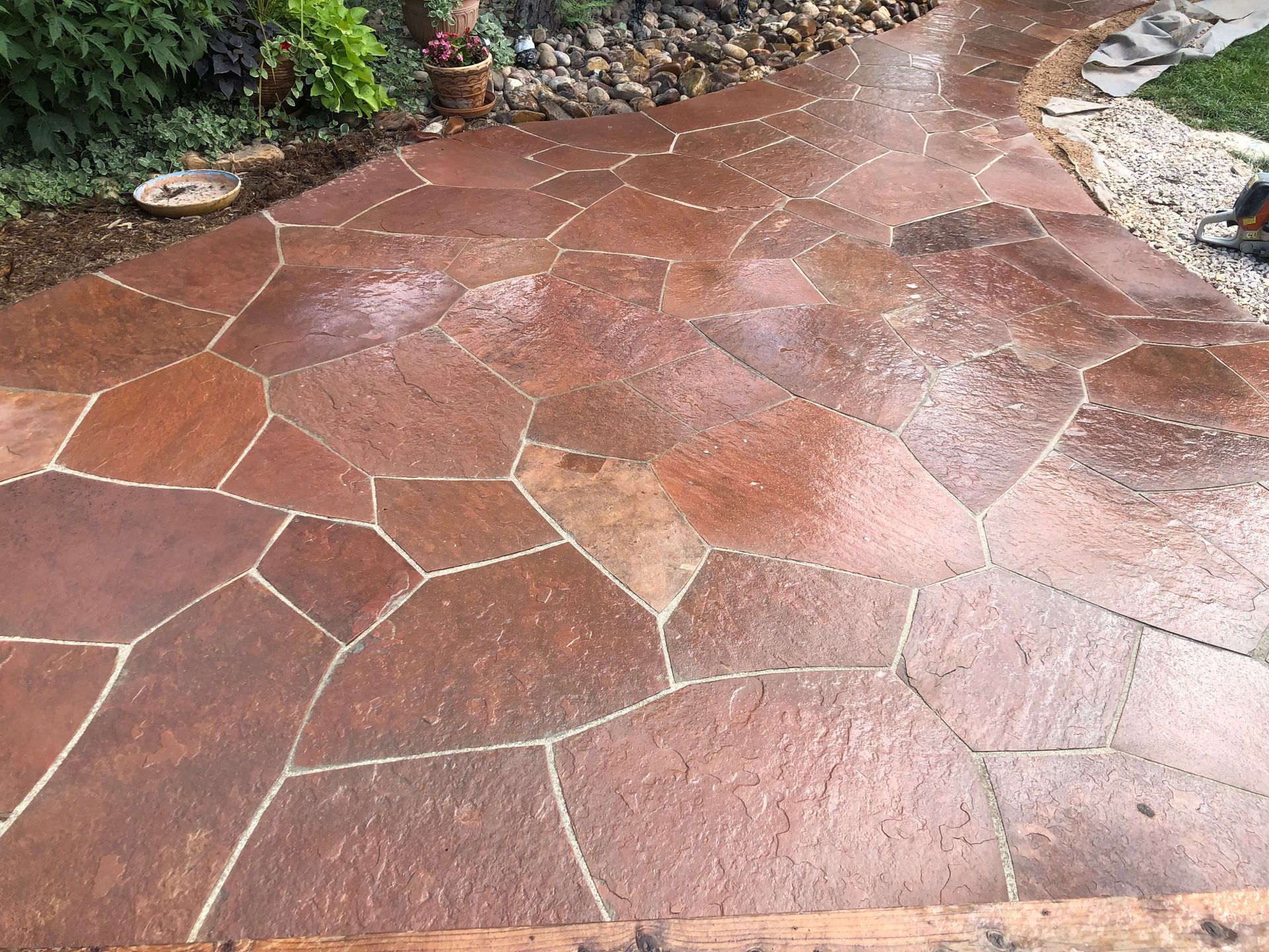 A patio with a lot of rocks on it in a garden.