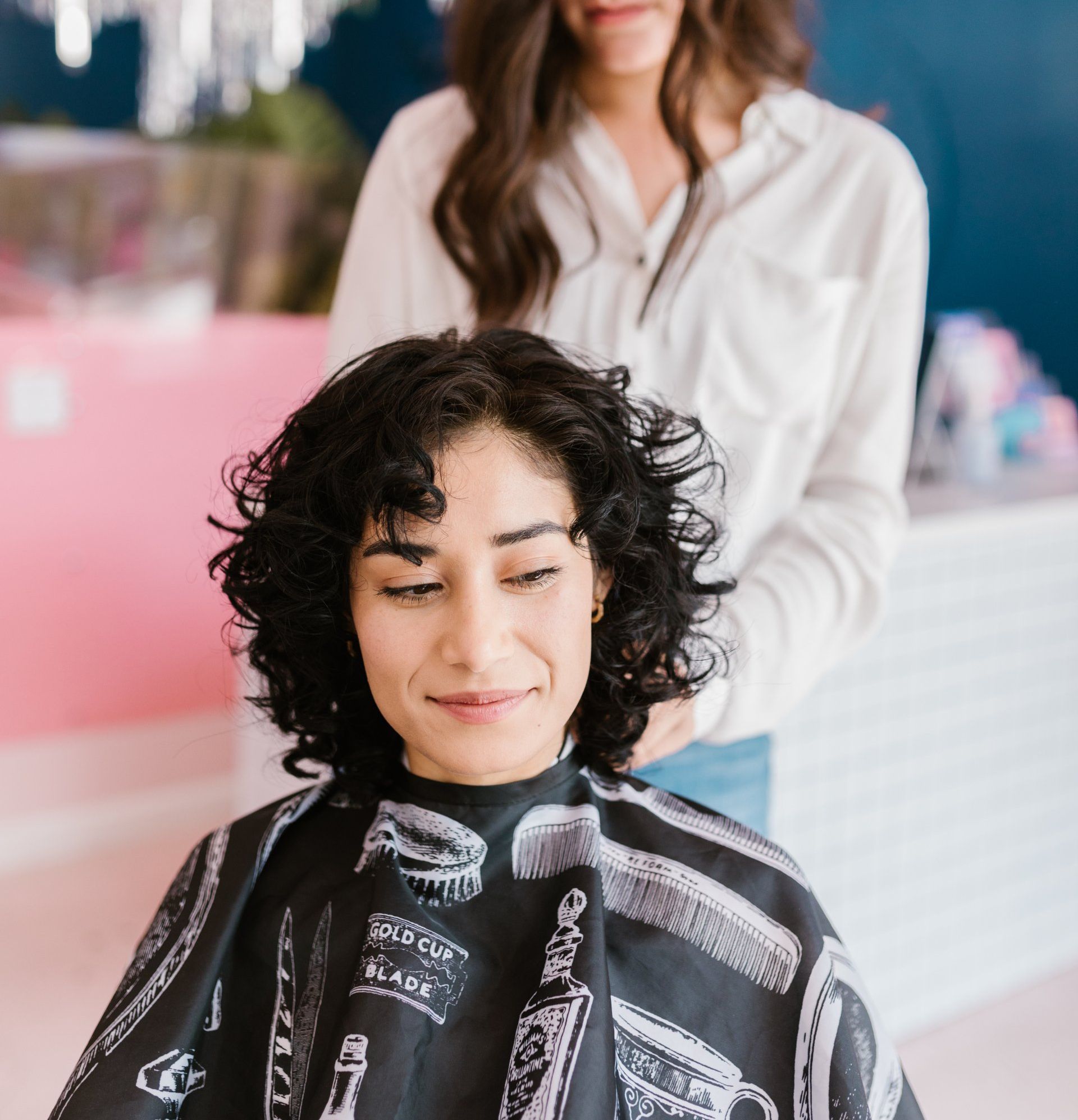 A woman is getting her hair cut by a hairdresser