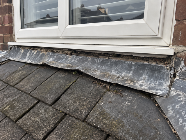 Lead flashing lifted away from the wall