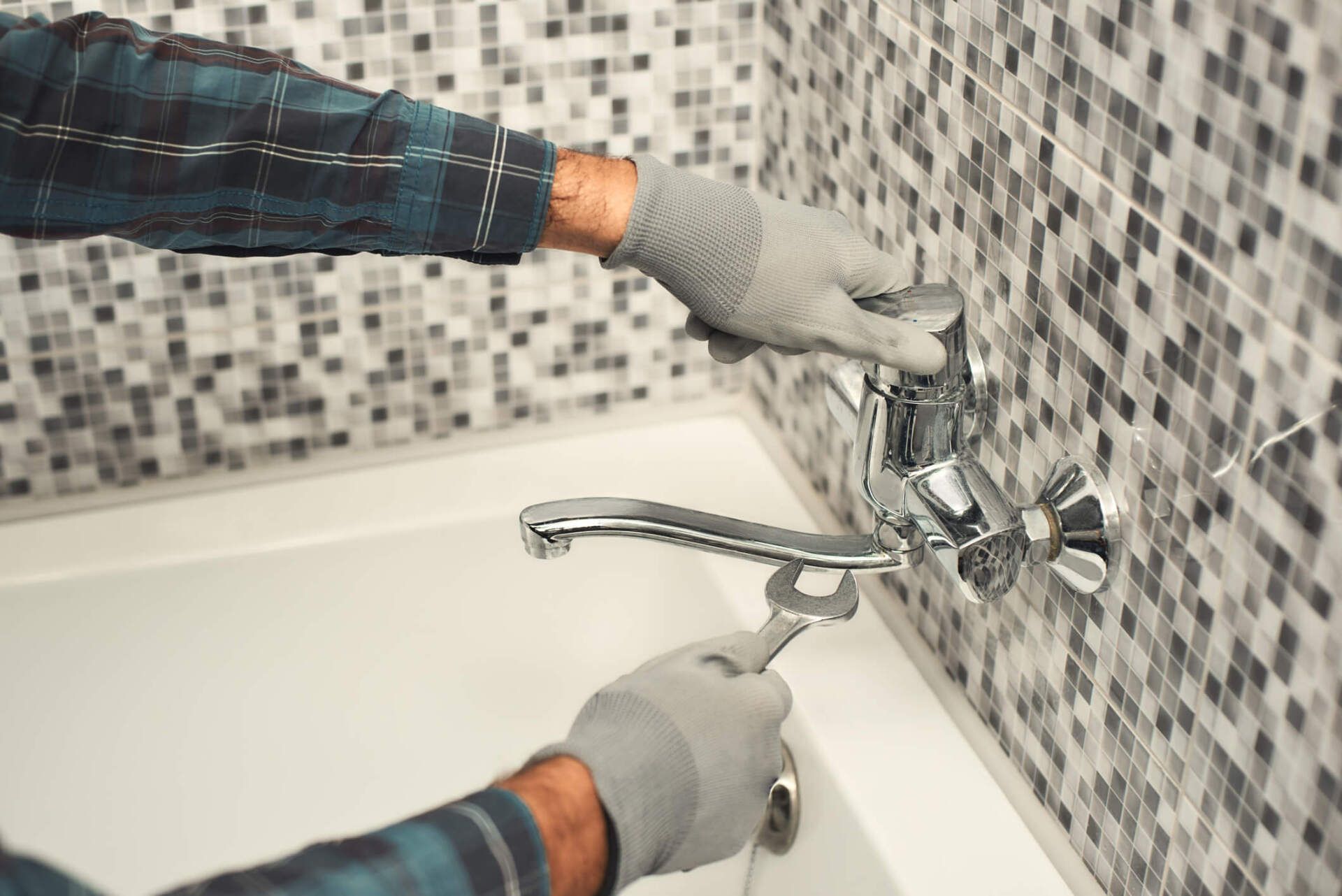 Plumber Repairing a Tap in the Bathroom — Rockford, IL — ProTech Plumbing Heating & Cooling
