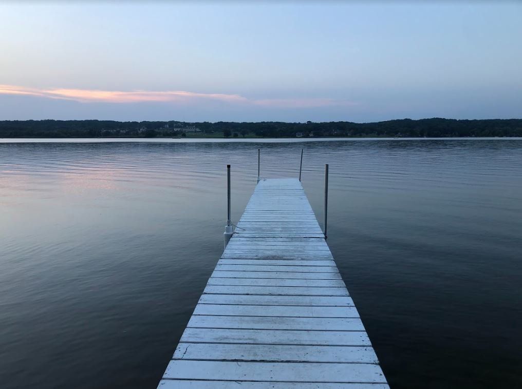 A wooden dock leading into a large body of water.