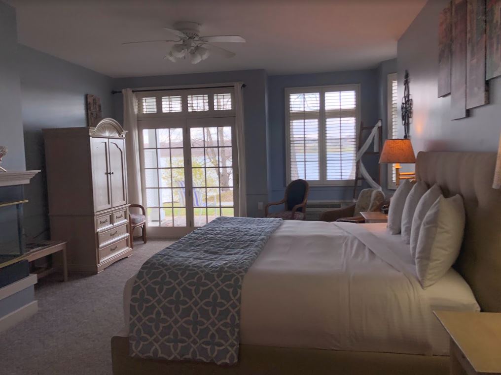 A hotel room with a large bed and a large window