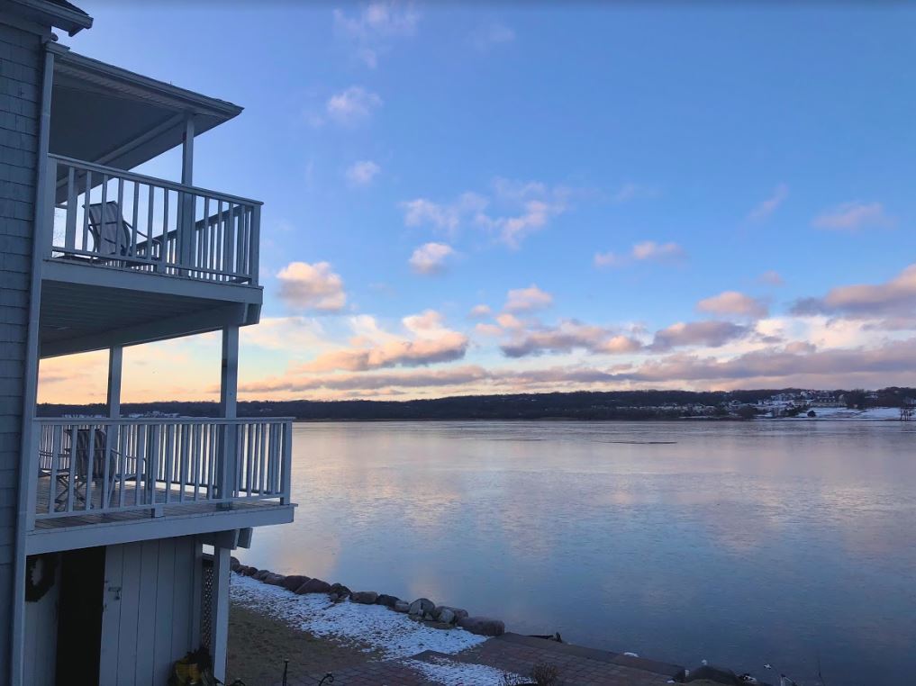 A house with a balcony overlooking a body of water