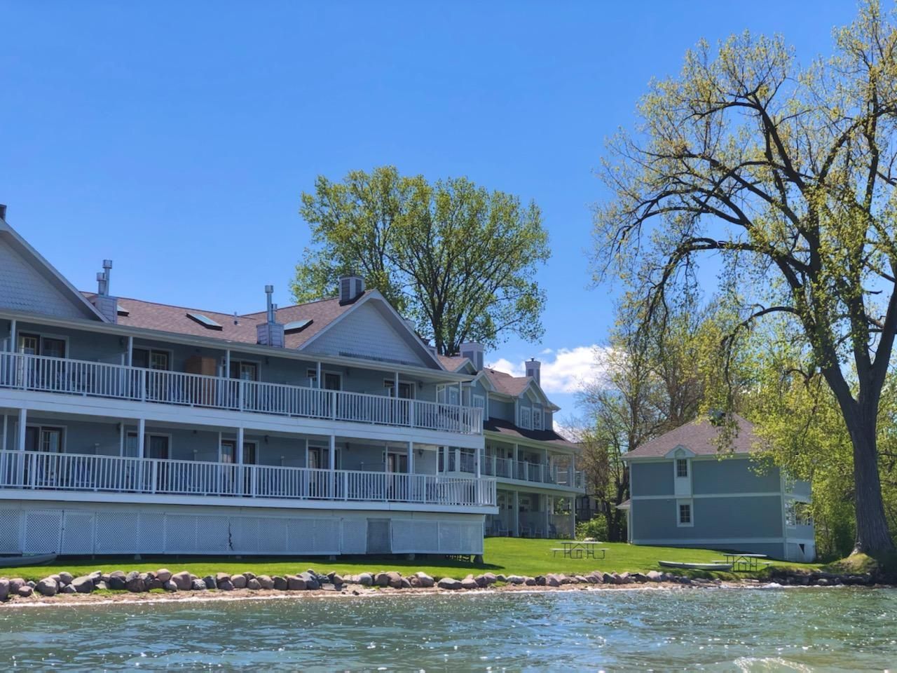 A large house is sitting on the shore of a lake.