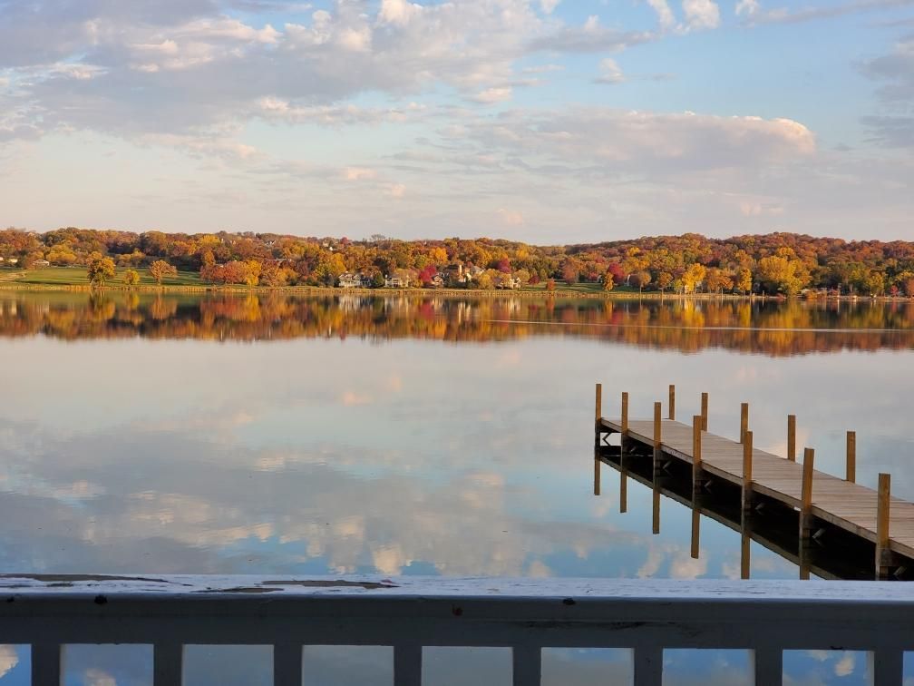 There is a dock in the middle of a lake.