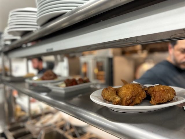 A plate of food is on a shelf in a kitchen