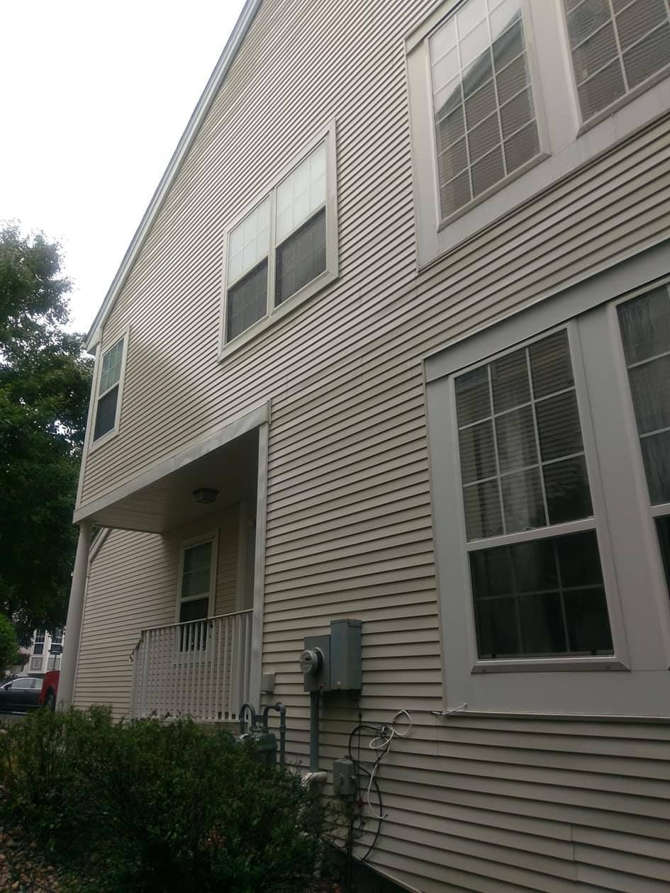 A large house with a lot of windows and a porch.