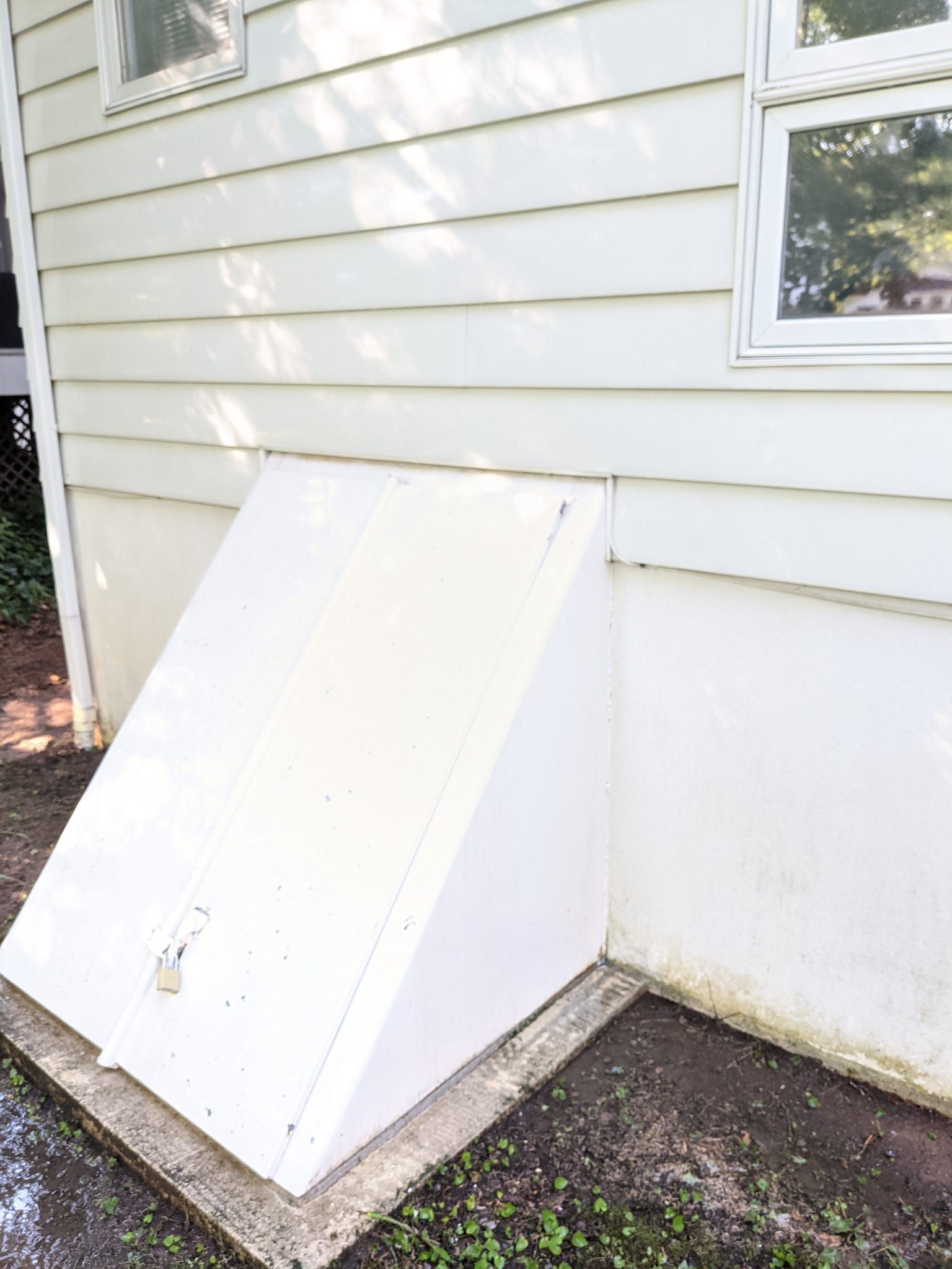 A white house with a white door on the side of it.