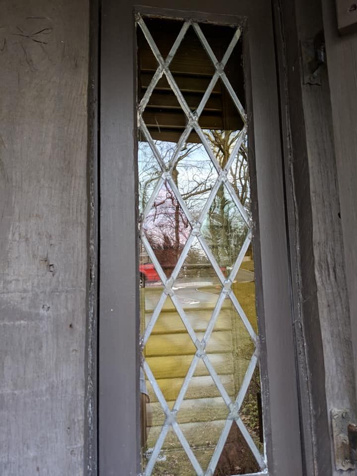 A door with a reflection of trees in it