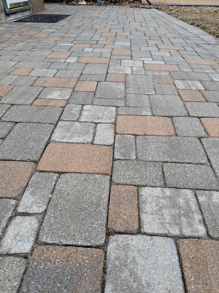 A brick walkway with a lot of bricks on it.