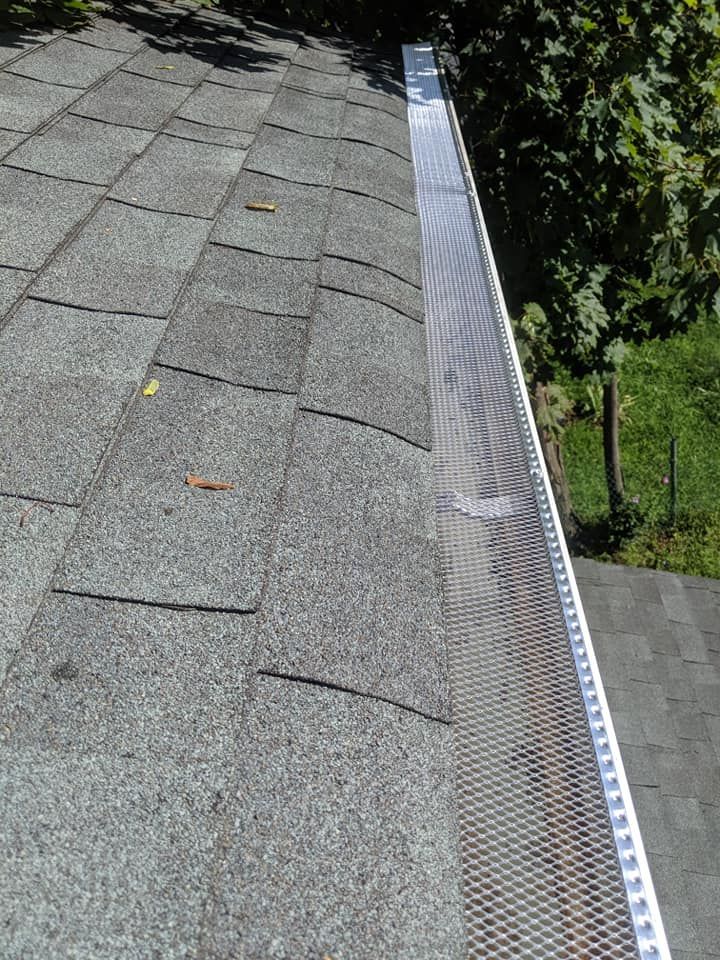 A close up of a gutter on the side of a roof.